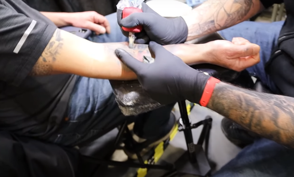 What is the distinction between a conventional tattoo machine and a rotary tattoo machine?